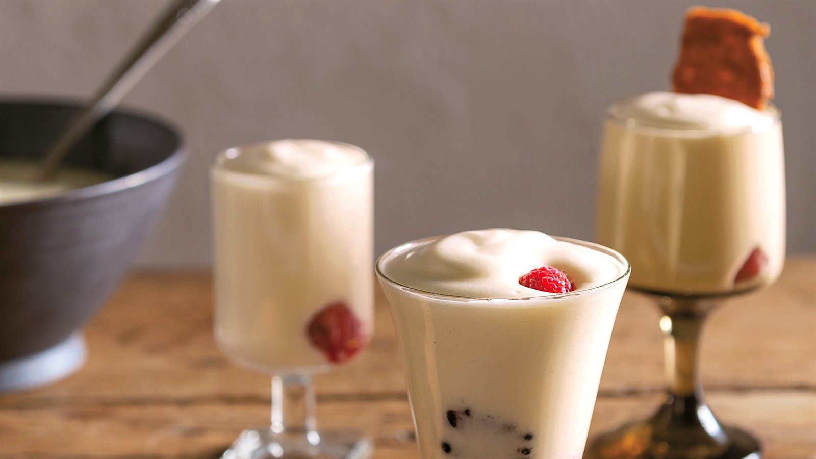 3 different parfait glasses filled with white wine mousse mixed with berries